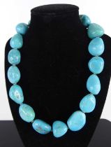 A turquoise knotted necklace, arranged as sixteen large soft polished odd-shaped beads, length 42cm