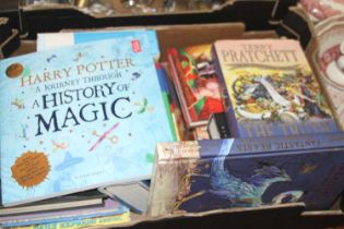 A collection of books, to include J.K. Rowling and Terry Pratchett