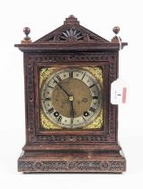 A 19th century oak cased mantel clock having an arched pediment with blind fret carved case, the