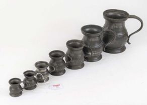 A matched set of seven 19th century and later pewter tankards, size ranging from a quart to a