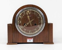 An Art Deco Enfield walnut cased dome top mantel clock, the applied metal chapter ring with Arabic