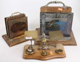 A set of vintage brass postal scales, w.24cm; together with two brass and oak stationery racks