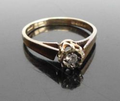 A modern 9ct gold diamond solitaire ring, arranged as a small illusion set round cut, sponsor A&