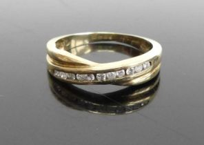 A modern 9ct gold diamond half hoop ring, arranged as elven channel set brilliants, total diamond