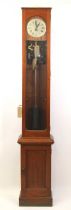 A teak cased Synchronome electric Master clock, having a signed silvered Roman dial, the glazed case