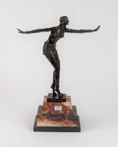 An Art Deco style bronzed metal figure of a dancer, mounted on a stepped polished hardstone