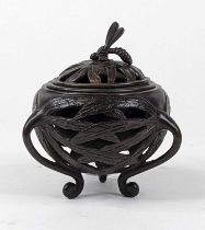 A Japanese Meiji period (1868-1912) bronze koro, the reticulated cover surmounted by a wasp, and