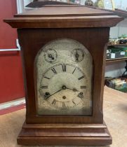 A 19th century mahogany cased mantel clock, the silvered dial with Roman numerals, two subsidiary