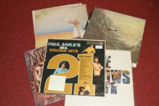 A collection of vintage rock & pop LPs to include Mike Oldfield, Paul Anka, and Simon & Garfunkel