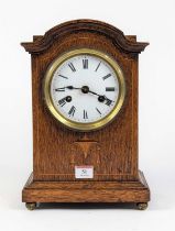 A late Victorian oak cased mantel clock, the enamel dial with Roman numeral markers and twin winding