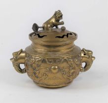 A Chinese brass censer the pieced cover surmounted by shishi finial, the body relief decorated