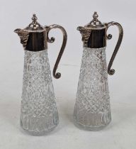 A pair of glass claret jugs, each having silver plated handle and Bacchus mask spout, h.27cm