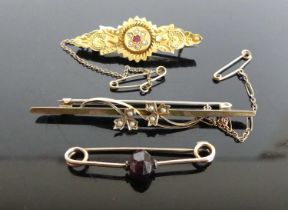 A yellow metal and seed pearl set bar brooch, with safety chain and steel pin, 58mm; together with a