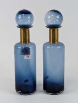A pair of modern blue glass bottles, each having a brass collar, height 41cm