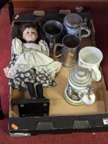 A 20th century bisque headed doll on stand, height 40cm, together with various tankards