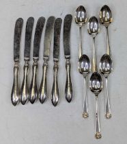 A set of six George V silver teaspoons, having shell cast terminals and backs; together with a set