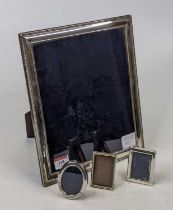 An Elizabeth II silver clad photograph frame, of rectangular form with beaded outer rim