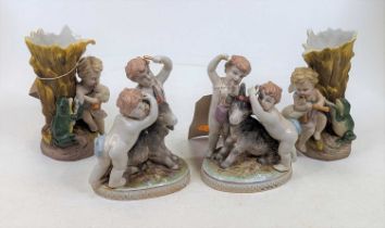 A pair of continental porcelain figure groups of putti playing with a goat, height 16cm, together