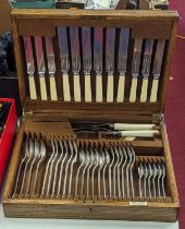 An early 20th century Mappin & Webb oak cased part canteen of cutlery, six place setting, case width