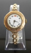 A vintage ladies 9ct gold cased wrist watch having manual wind movement and on gilt metal