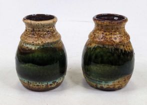 A pair of mid 20th century West German pottery vases, each having a mottled brown and green glaze,