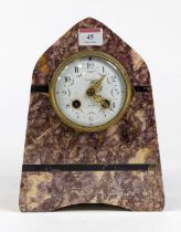 A late 19th century French rouge marble cased mantel clock of lancet shape, the enamel dial with