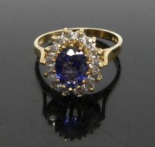 A modern 9ct gold blue sapphire and CZ set cluster ring, 3.1g, size N, setting measurements approx
