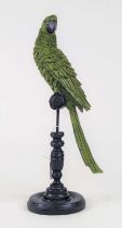 A painted resin figure of a parrot upon a perch, height 42cm