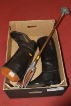 A pair of vintage leather riding boots together with a shooting stick