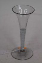 A wine glass, having a multi-series opaque twist stem and drawn trumpet bowl, h.16cm