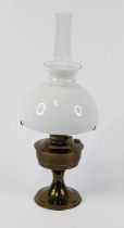 A Victorian brass oil lamp, having a milk glass shade, height 60cm