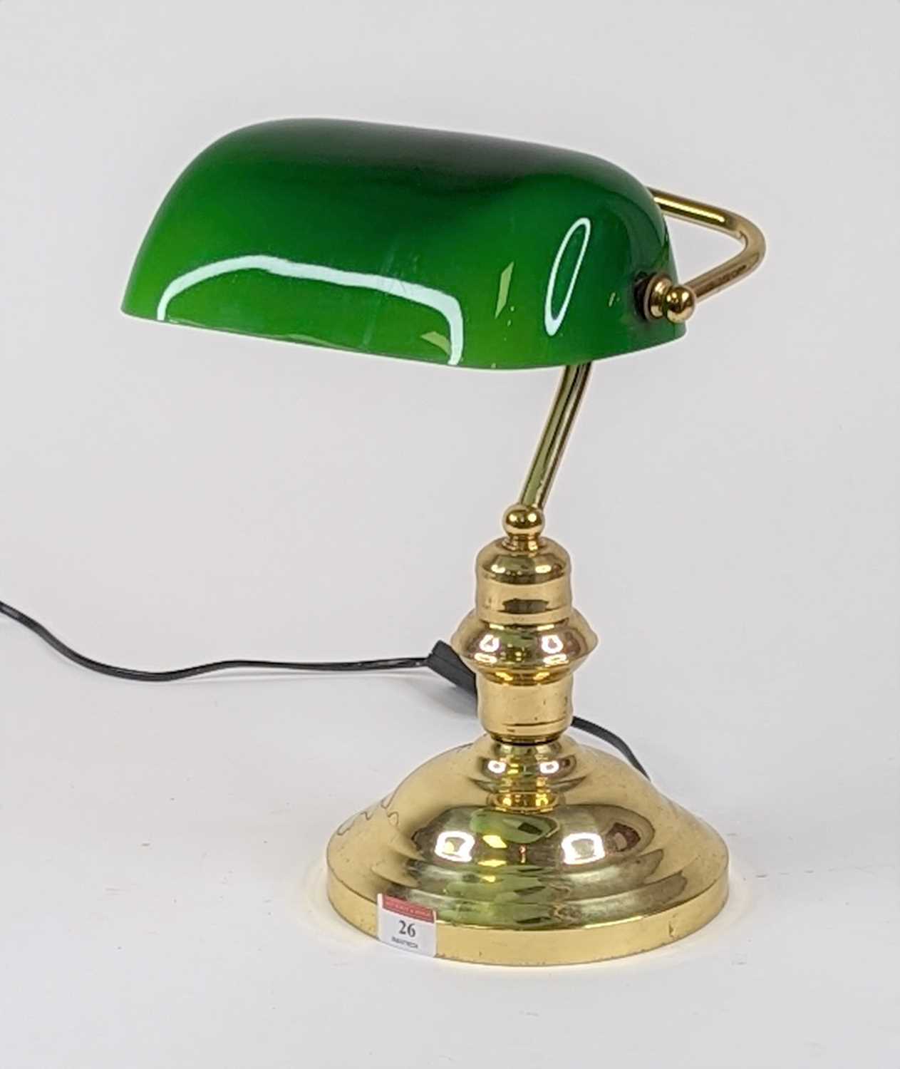 An early 20th century style banker's desk lamp having a green glass shade on a brass base, height