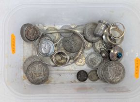 A collection of mixed coinage to include George V half crowns, silver ear clip, thimble, bangle,