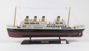 A painted wooden model of The Titanic on stand, length 49cm