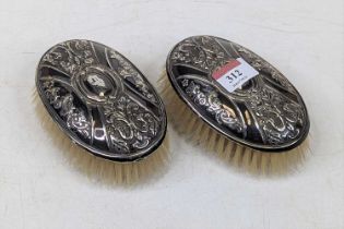 *A pair of Victorian silver clad clothes brushes, each having engraved oval cartouche and repousse