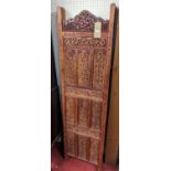 *A contemporary Indonesian relief carved and pierced teak four-fold dressing screen, each panel