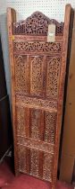 *A contemporary Indonesian relief carved and pierced teak four-fold dressing screen, each panel