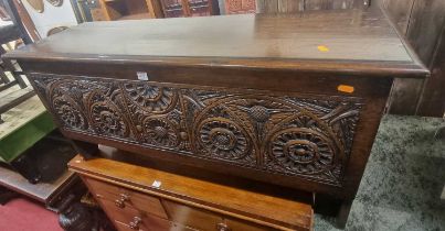 *A contemporary joined oak six plank blanket chest, the front panel profusely floral relief