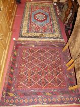 *A Persian woollen red and blue ground Oushak rug, 180 x 106cm; together with a red ground woollen
