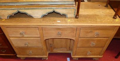A mid-Victorian pine round cornered dresser base, having an arrangement of seven short drawers and