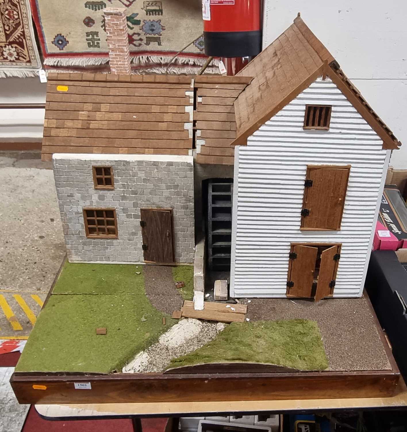 A scratch built dolls house model of a mill with furniture and accessories included