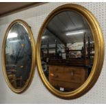Two gilt framed oval wall mirrors, the larger 82 x 52cm