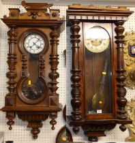 Two early 20th century walnut Vienna style drop trunk wall clocks, each with pendulum