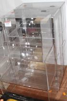 A quantity of plastic shelving and showcases for model vehicles