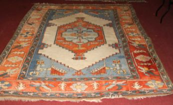 A Turkish woollen multicoloured ground rug, with all-over abstract geometric stylised decoration,