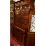 An early Victorian mahogany and flame mahogany secretaire bookcase, having twin door glazed upper