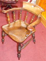 A circa 1900 elm and fruitwood tub captain's chair, raised on turned supports, width 63.5cm