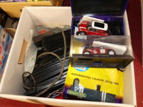 A box containing Scalextric cars and accessories