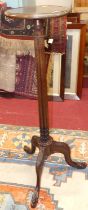 *An early 20th century mahogany plant stand, the circular top raised on reeded column to acanthus