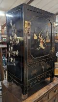 *An Oriental black lacquered gilt decorated and hardstone inset single door side cupboard, with